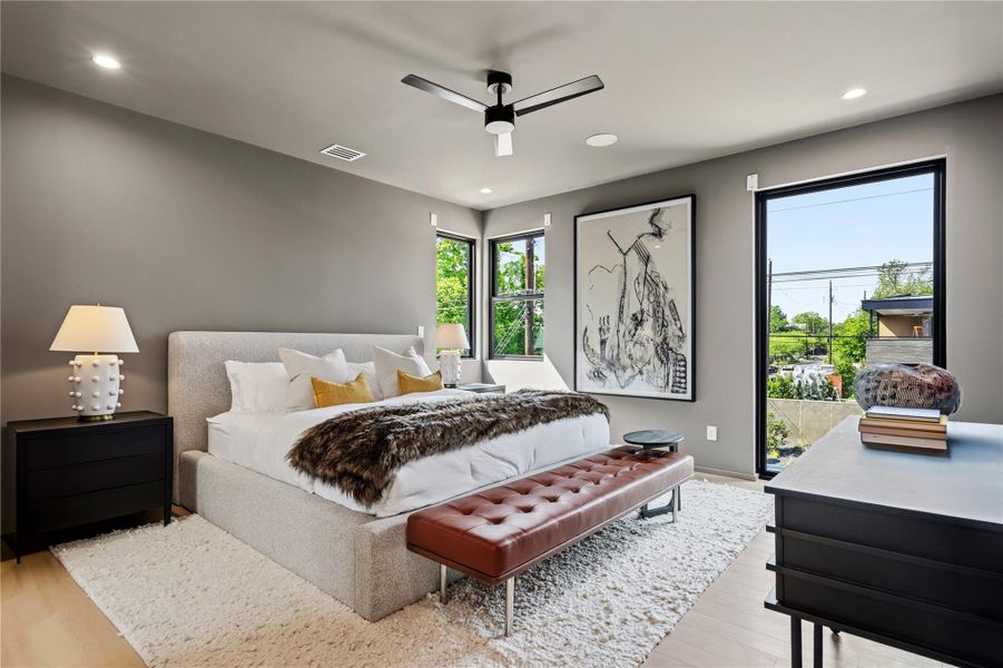 Bright windows and recessed lighting illuminate this primary suite, offering a serene escape.
