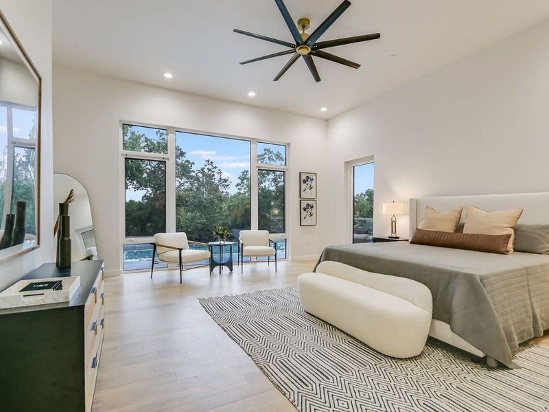 Floor-to-ceiling windows offer serene outdoor views from this comfortable, naturally illuminated bedroom. Floor-to-ceiling windows offer serene outdoor views from this comfortable, naturally illuminated bedroom.