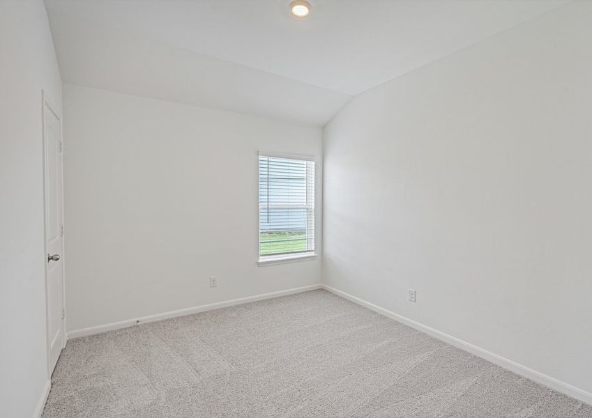 Secondary bedroom with lush carpet flooring