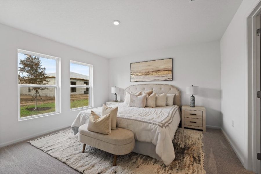 A bedroom with a bed and a couch.