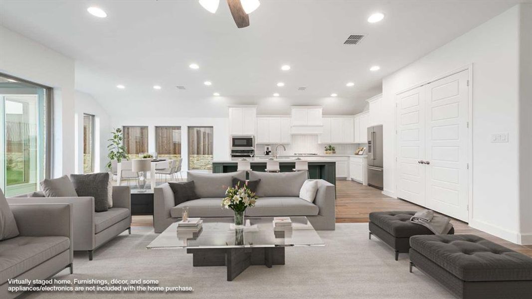 Living room with ceiling fan, light hardwood / wood-style flooring, and sink