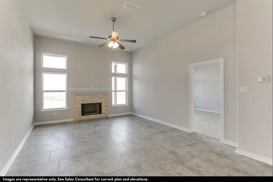 The spacious family room showcases soaring ceilings, beautiful flooring, and abundant natural light, creating a bright and inviting gathering space perfect for relaxing evenings or entertaining guests. (This home does not have a fireplace). **Photos are representative only and may vary as built. **