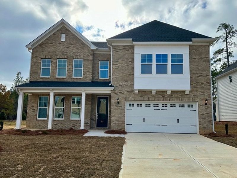 Front exterior of a new home in Pebble Branch, Chapin, SC, highlighting curb appeal (Image 1). Front exterior of a new home in Pebble Branch, Chapin, SC, highlighting curb appeal (Image 1).