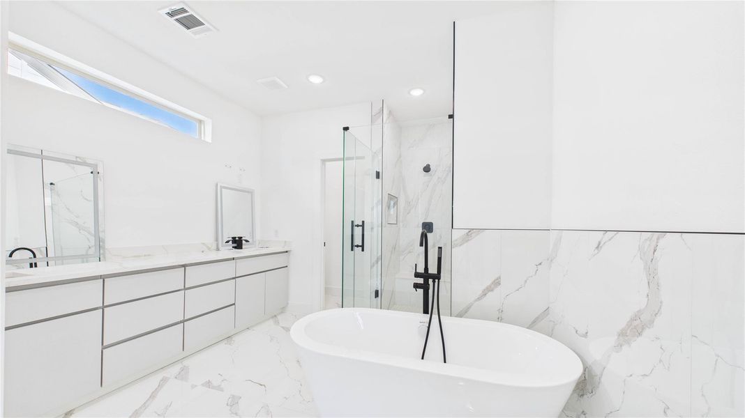 Primary oasis with soak in tub and stand up shower