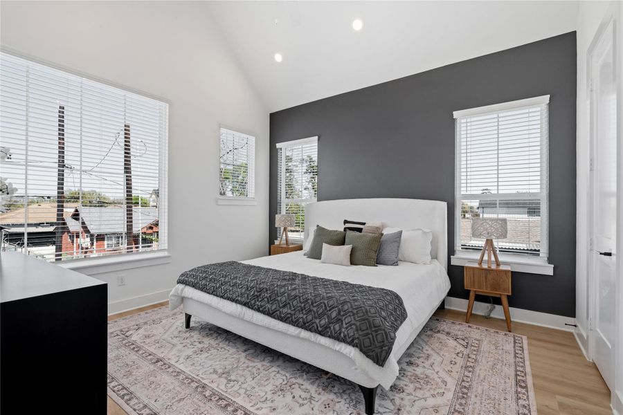 Spacious primary bedroom with 10’ ceilings, large windows, and a bright, airy feel.Aerial view showcasing the single-family home’s proximity to Downtown and surrounding development.