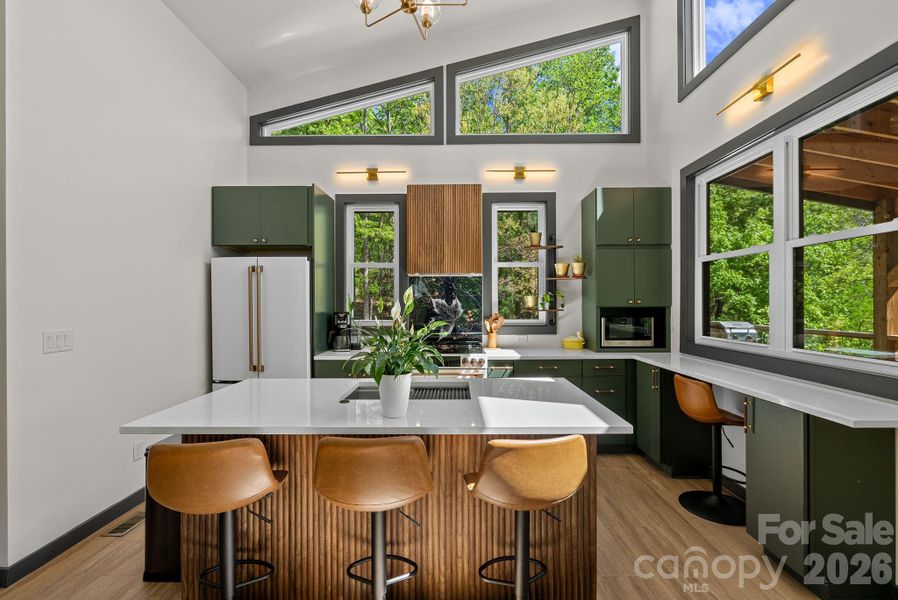 A small space living large - the kitchen, island with bar seating and living area create an intimate gathering space.