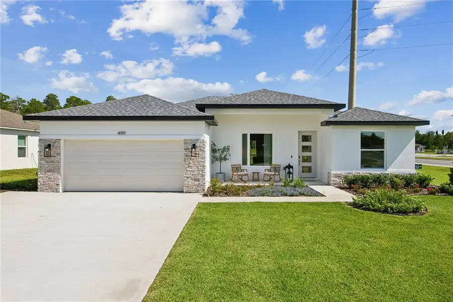 Front exterior of a new home in , Palm Coast, FL, highlighting curb appeal (Image 1). Front exterior of a new home in , Palm Coast, FL, highlighting curb appeal (Image 1).