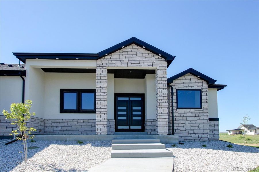 Front exterior of a new home in , Strasburg, CO, highlighting curb appeal (Image 23).