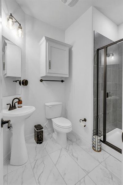 Bathroom with tile patterned flooring, toilet, and walk in shower