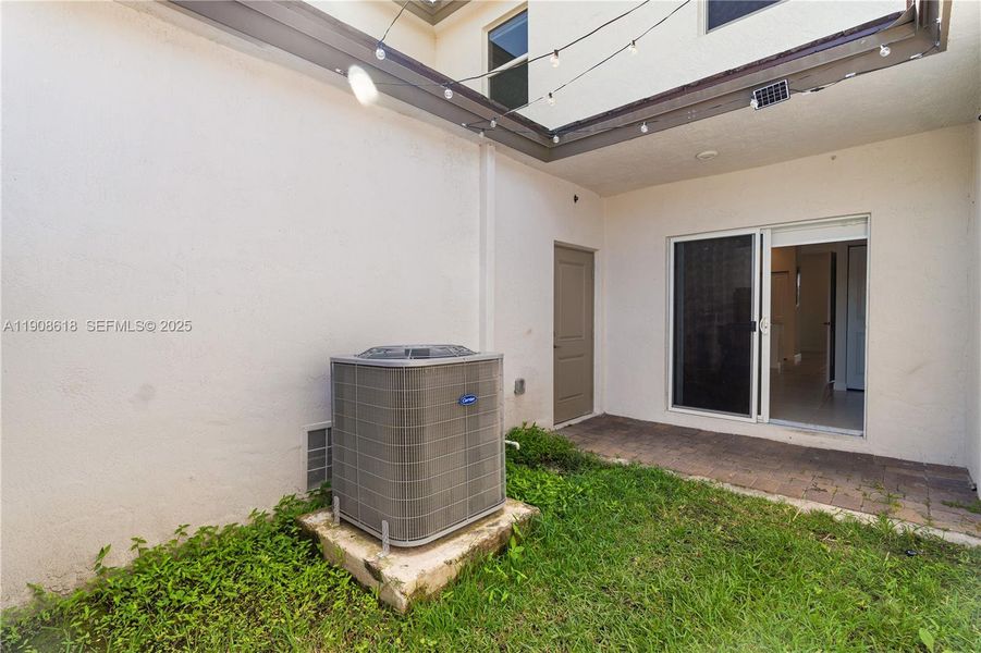 Exterior details and patio area of a home in Harmony Parc, Homestead (Image 3).