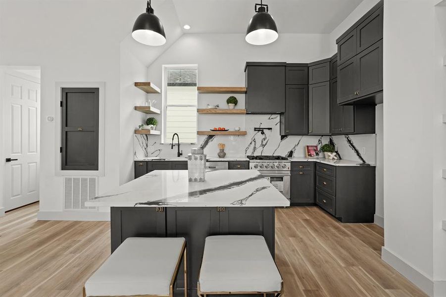 Kitchen with breakfast bar, high end quartz countertops and custom cabinets (throughout the entire home)