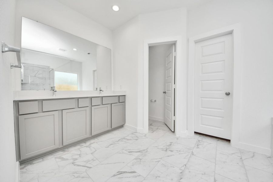Elevate your daily routine at the elegant vanity, now equipped with double sinks, light countertops, modern hardware, and beautiful recessed lights. Elevate your daily routine at the elegant vanity, now equipped with double sinks, light countertops, modern hardware, and beautiful recessed lights.