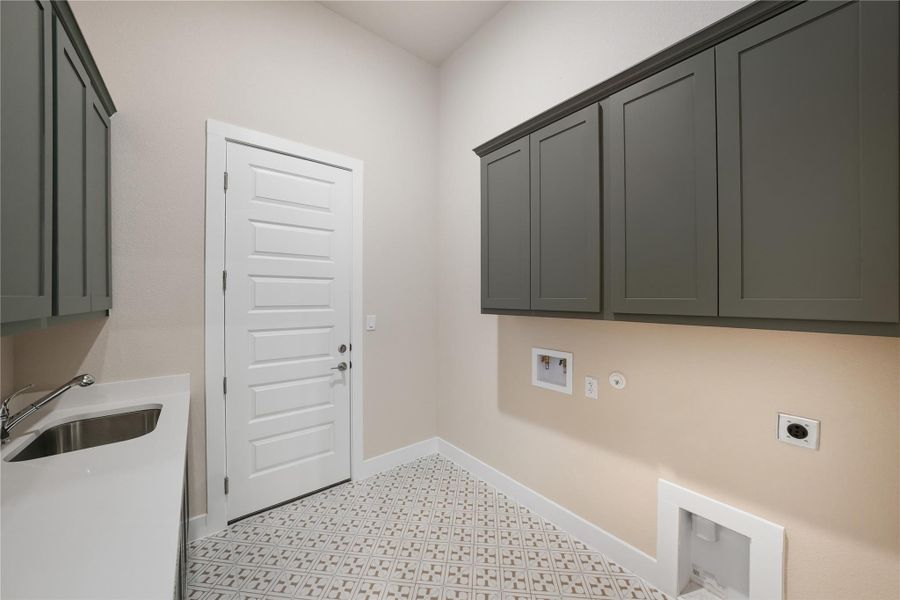 Laundry area featuring cabinet space, hookup for an electric dryer, gas dryer hookup, washer hookup, and light floors