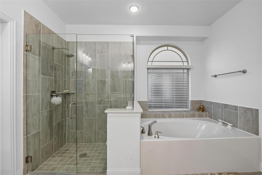 Full bathroom featuring a garden tub and a stall shower Full bathroom featuring a garden tub and a stall shower