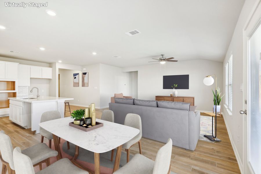 Virtually staged dining room and living room in the Fitzhugh floorplan at a Meritage homes community.