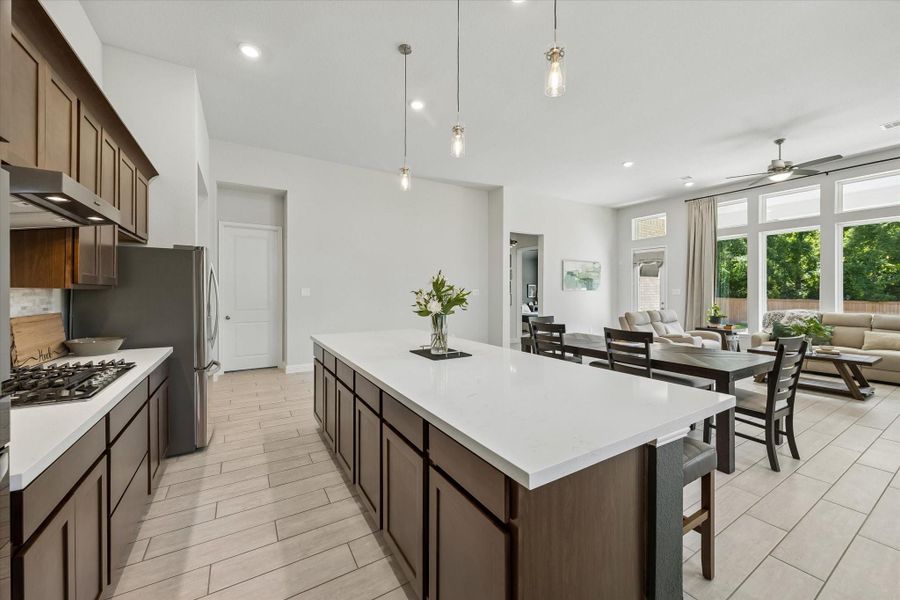 Massive central island serves as the perfect prep station and casual breakfast bar. Massive central island serves as the perfect prep station and casual breakfast bar.