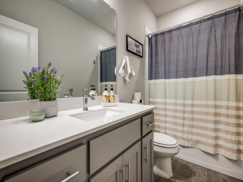 Guest bathroom offers a bath-tub combo and a large vanity sink!