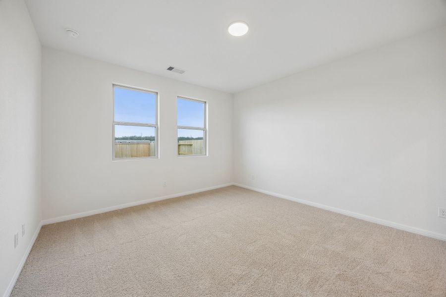 Primary Bedroom in the Magnolia home plan by Trophy Signature Homes – REPRESENTATIVE PHOTO