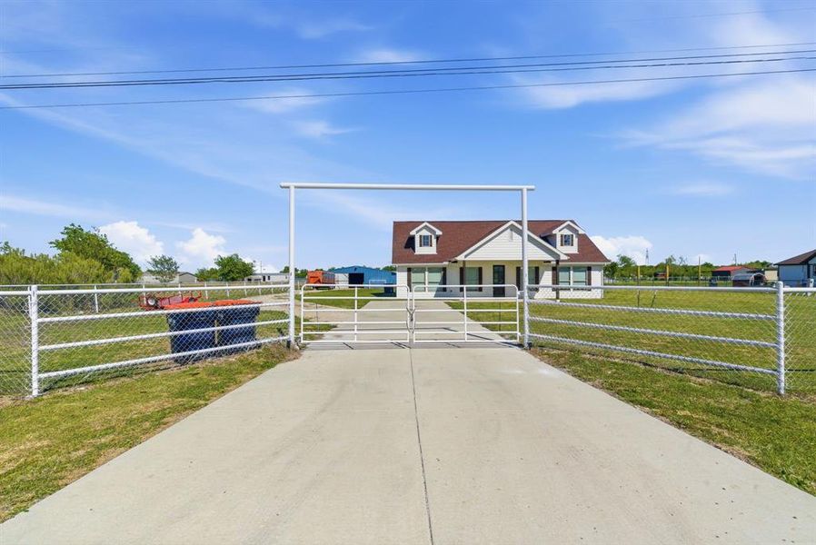View of front of home with a fenced front yard and a gate View of front of home with a fenced front yard and a gate