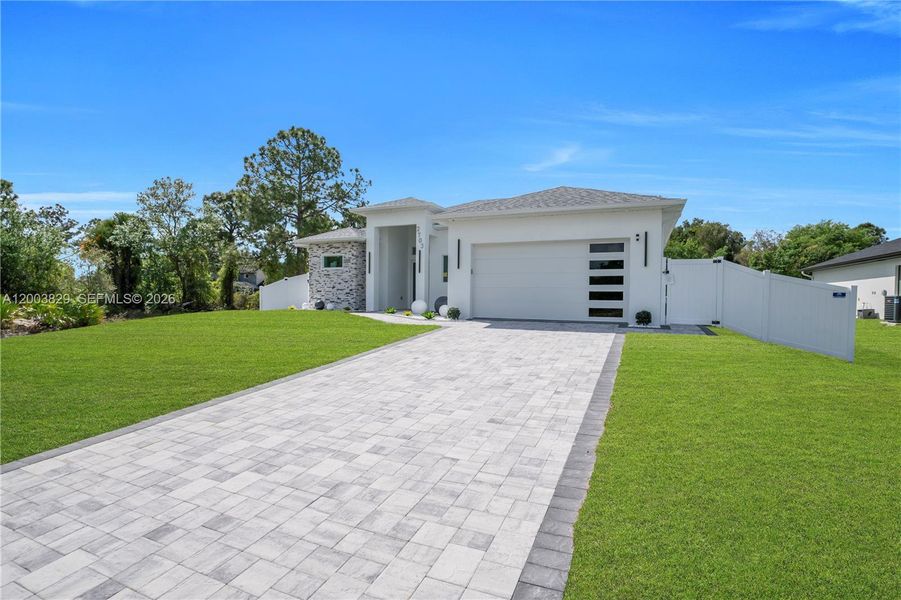 Front exterior of a new home in , Lehigh Acres, FL, highlighting curb appeal (Image 24). Front exterior of a new home in , Lehigh Acres, FL, highlighting curb appeal (Image 24).