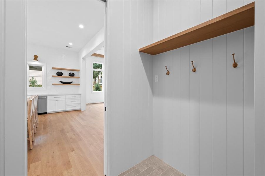 Designer mudroom with convenient entrance from garage to kitchen and extra space included for a second fridge