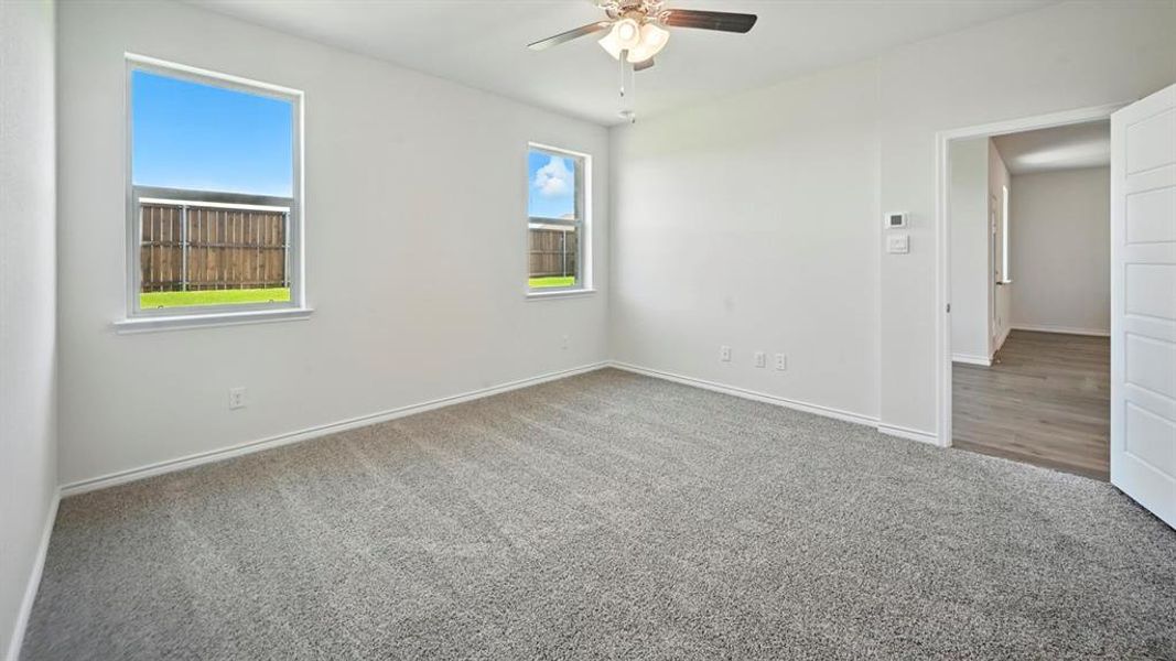 Spacious room with light gray carpet and white walls