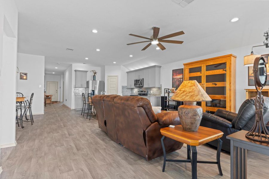 Wide shot of the main living space shows the open hallway leading toward bedrooms and additional areas, all while keeping the heart of the home beautifully connected for easy flow. Wide shot of the main living space shows the open hallway leading toward bedrooms and additional areas, all while keeping the heart of the home beautifully connected for easy flow.