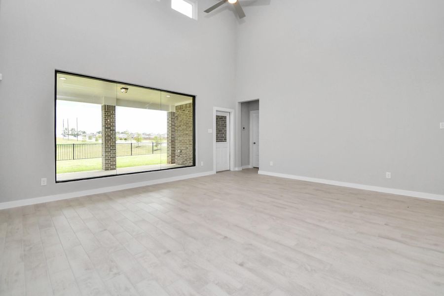 Family room with scenic views of the water. Sample photo of completed home with similar floor plan. Actual colors and selections may vary. Family room with scenic views of the water. Sample photo of completed home with similar floor plan. Actual colors and selections may vary.