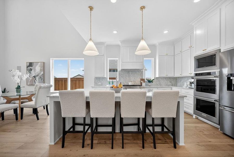 Kitchen with a kitchen island, white cabinetry, healthy amount of natural light, stainless steel appliances, and recessed lighting Kitchen with a kitchen island, white cabinetry, healthy amount of natural light, stainless steel appliances, and recessed lighting