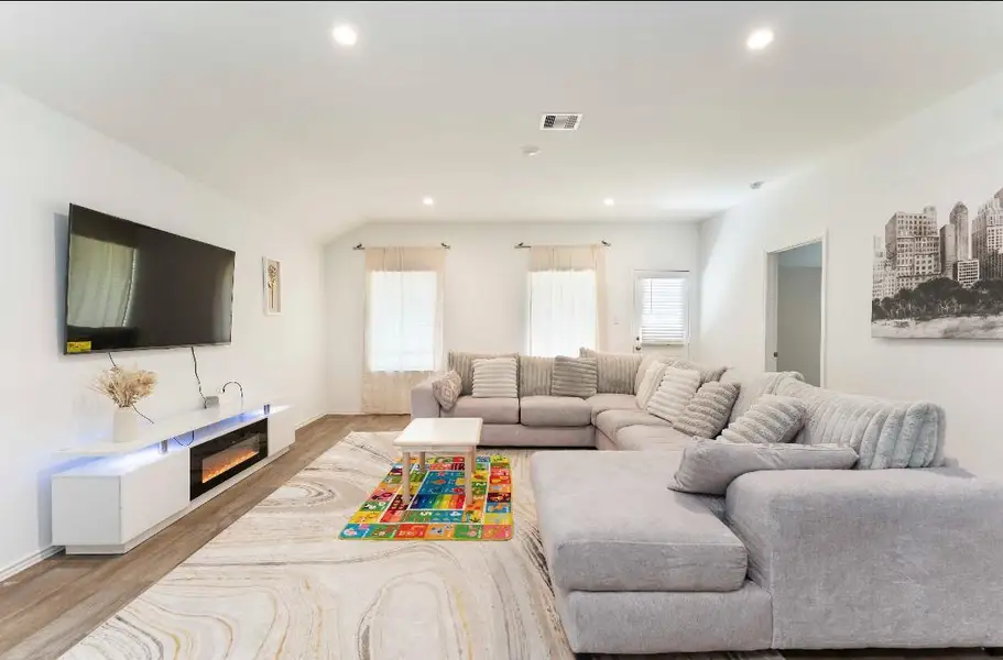 Bright and inviting living room with expansive windows. Bright and inviting living room with expansive windows.