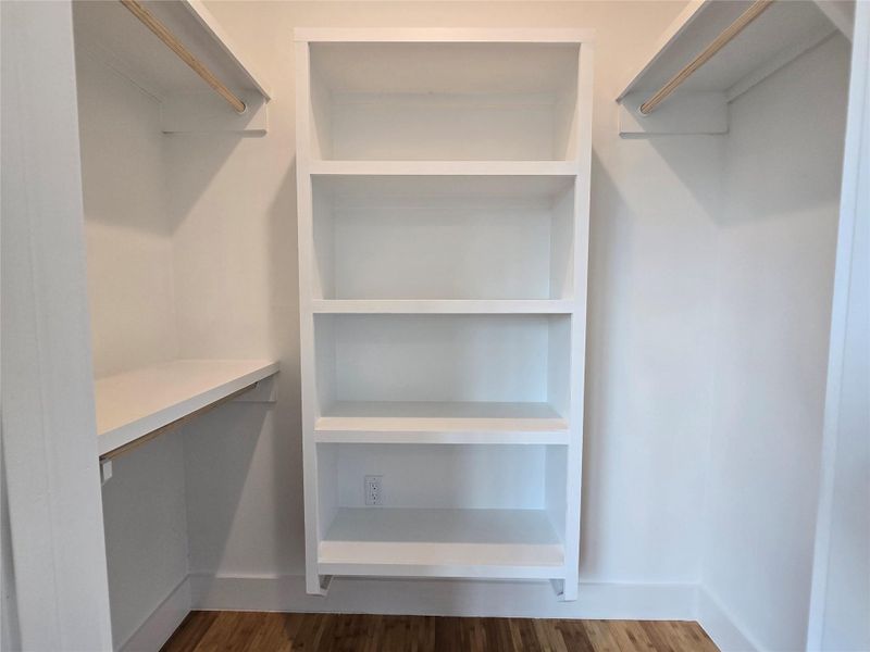 Walk in closet featuring dark wood-style floors