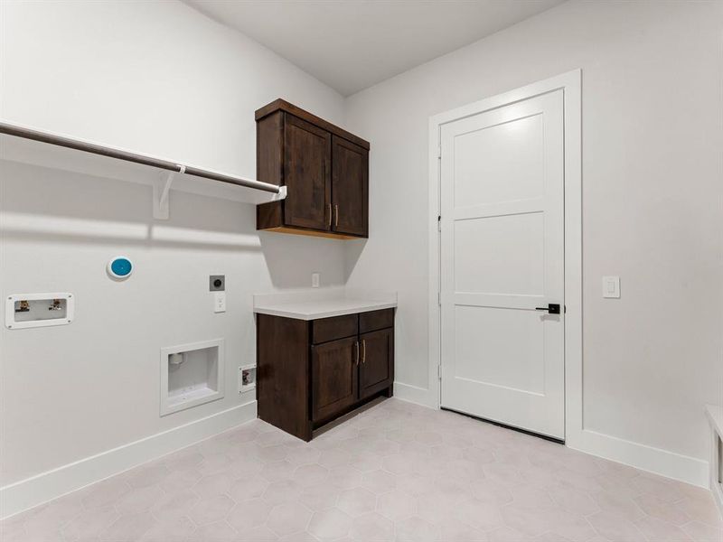 Utility Room with Washer and Dryer Connections, Hanging Bar, Storage, and Built-in Folding Area.