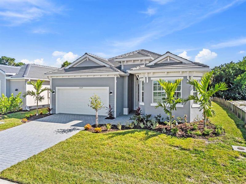Front exterior of a new home in Sandy Key, Fort Myers, FL, highlighting curb appeal (Image 1).