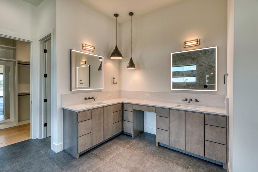 Clean lines and a spacious dual-sink vanity define this modern primary bath design.