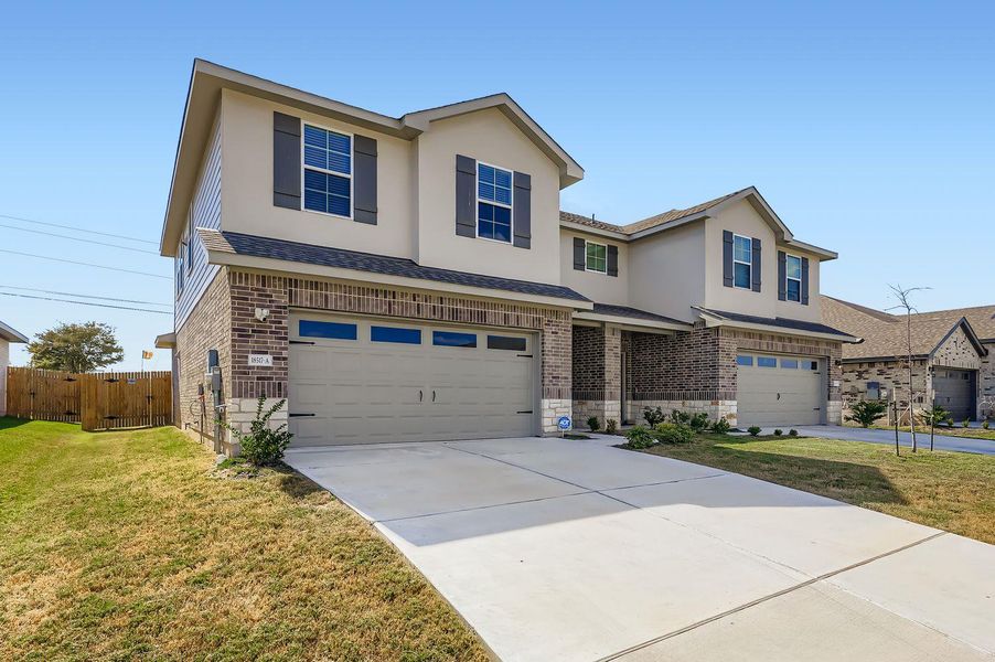 Front exterior of a new home in Palomino, Manor, TX, highlighting curb appeal (Image 1). Front exterior of a new home in Palomino, Manor, TX, highlighting curb appeal (Image 1).
