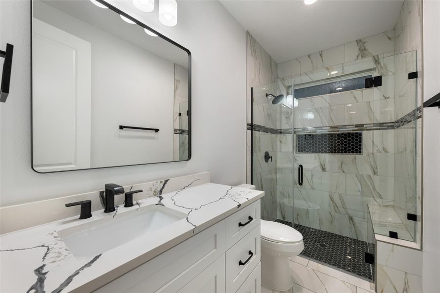 Bathroom with vanity and a stall shower