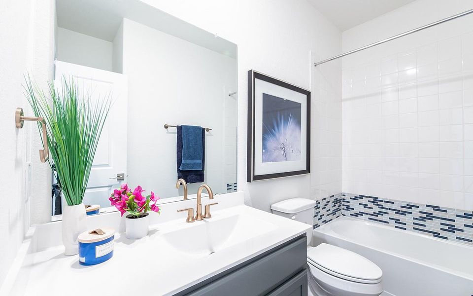 Bathroom featuring toilet, vanity, and shower / bathtub combination Bathroom featuring toilet, vanity, and shower / bathtub combination