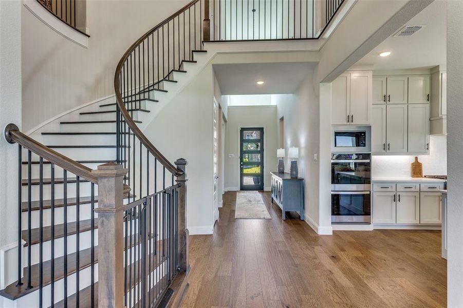 Foyer with light wood finished floors, recessed lighting, and a high ceiling Foyer with light wood finished floors, recessed lighting, and a high ceiling