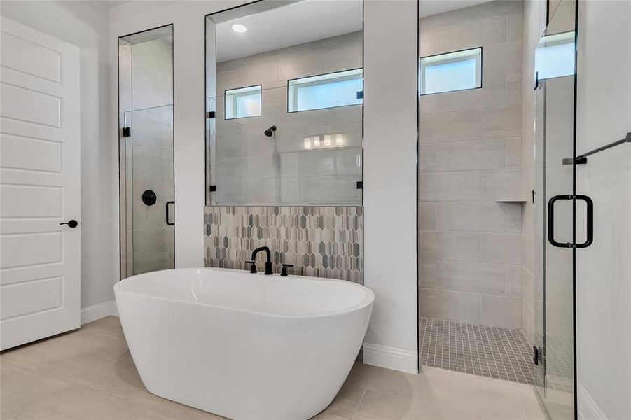 Bathroom with tile walls, independent shower and bath, and tile patterned floors