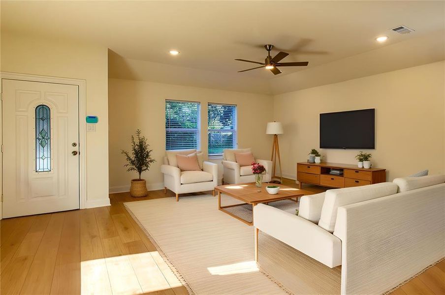 Living area featuring light wood finished floors, a ceiling fan, and recessed lighting Living area featuring light wood finished floors, a ceiling fan, and recessed lighting