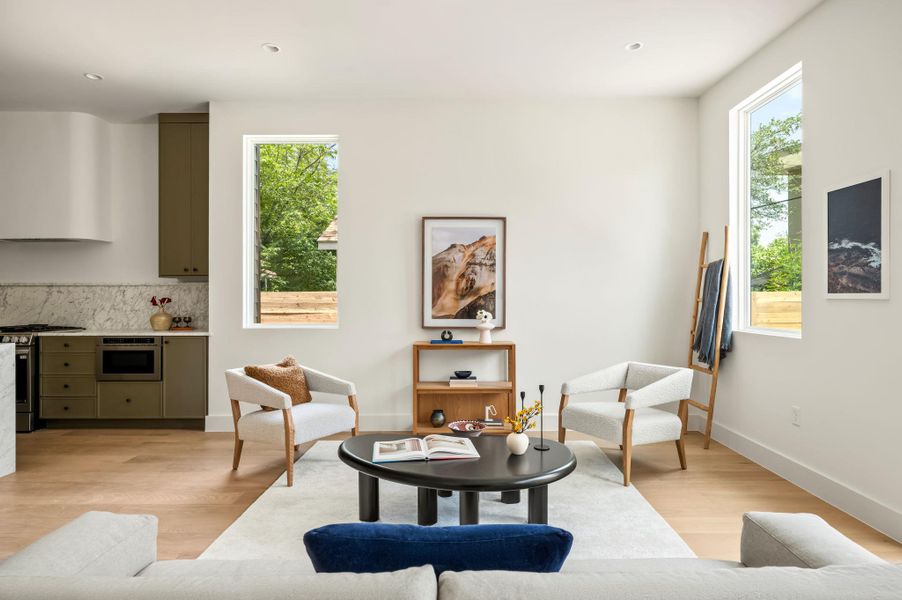 An open concept living area boasts sleek hardwood floors and an inviting atmosphere.