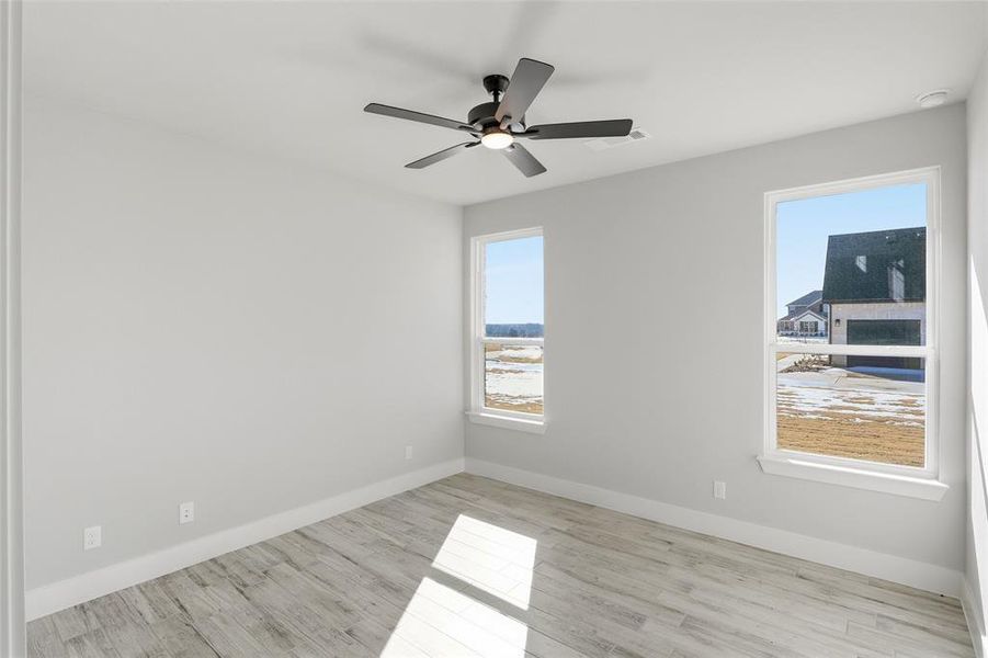 Spare room with light wood-type flooring and a ceiling fan