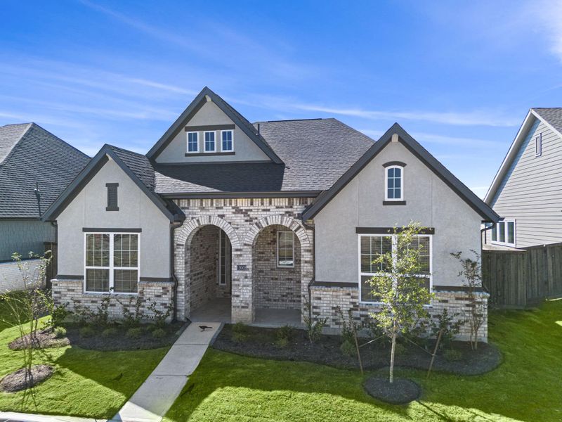Front exterior of a new home in Riceland, Mont Belvieu, TX, highlighting curb appeal (Image 2). Front exterior of a new home in Riceland, Mont Belvieu, TX, highlighting curb appeal (Image 2).