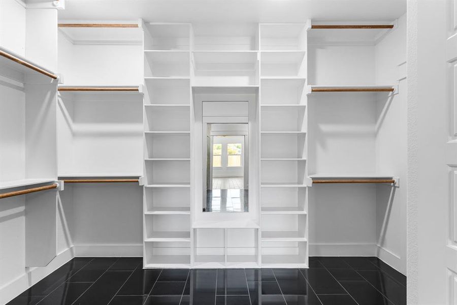 Walk in closet featuring dark tile patterned floors