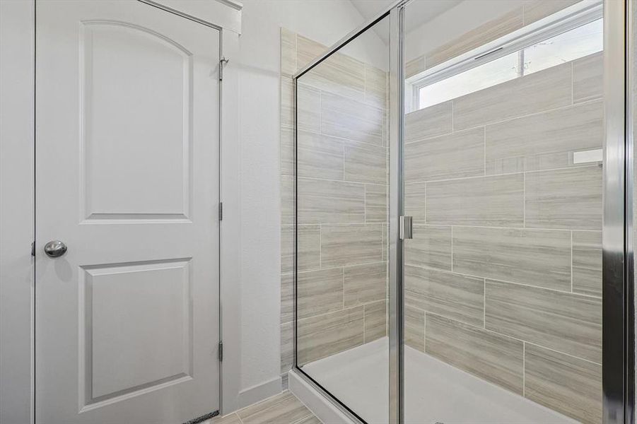 Bathroom featuring a shower with shower door