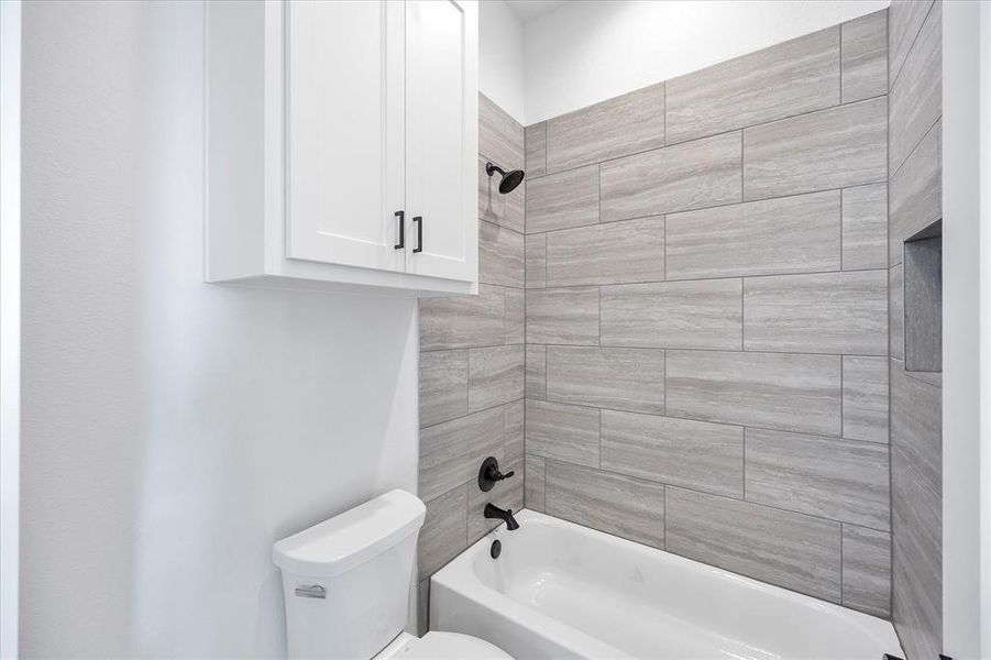 Bathroom with toilet and tub / shower combination Bathroom with toilet and tub / shower combination