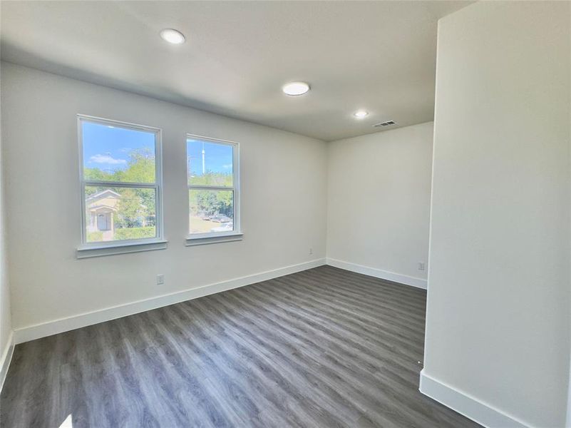 Unfurnished room featuring dark hardwood / wood-style flooring