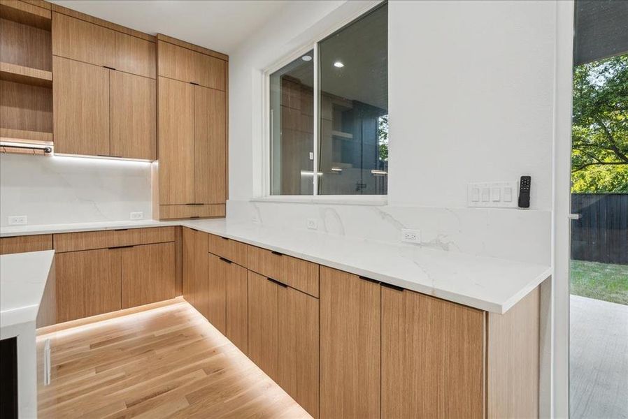 Kitchen featuring light stone counters and light hardwood / wood-style floors