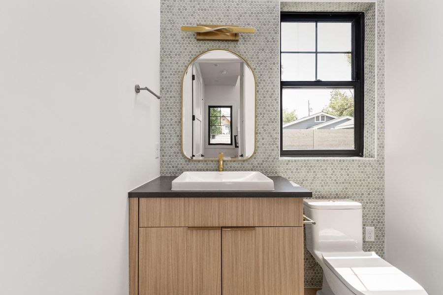 Half bath featuring vanity and toilet Half bath featuring vanity and toilet