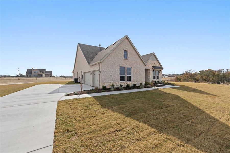 Front exterior of a new home in Eagle Ridge Estates, Weatherford, TX, highlighting curb appeal (Image 22).